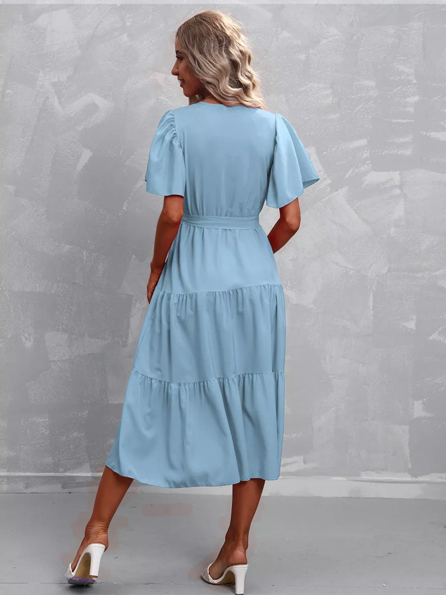 Light blue tiered midi dress with flutter sleeves and belted waist.