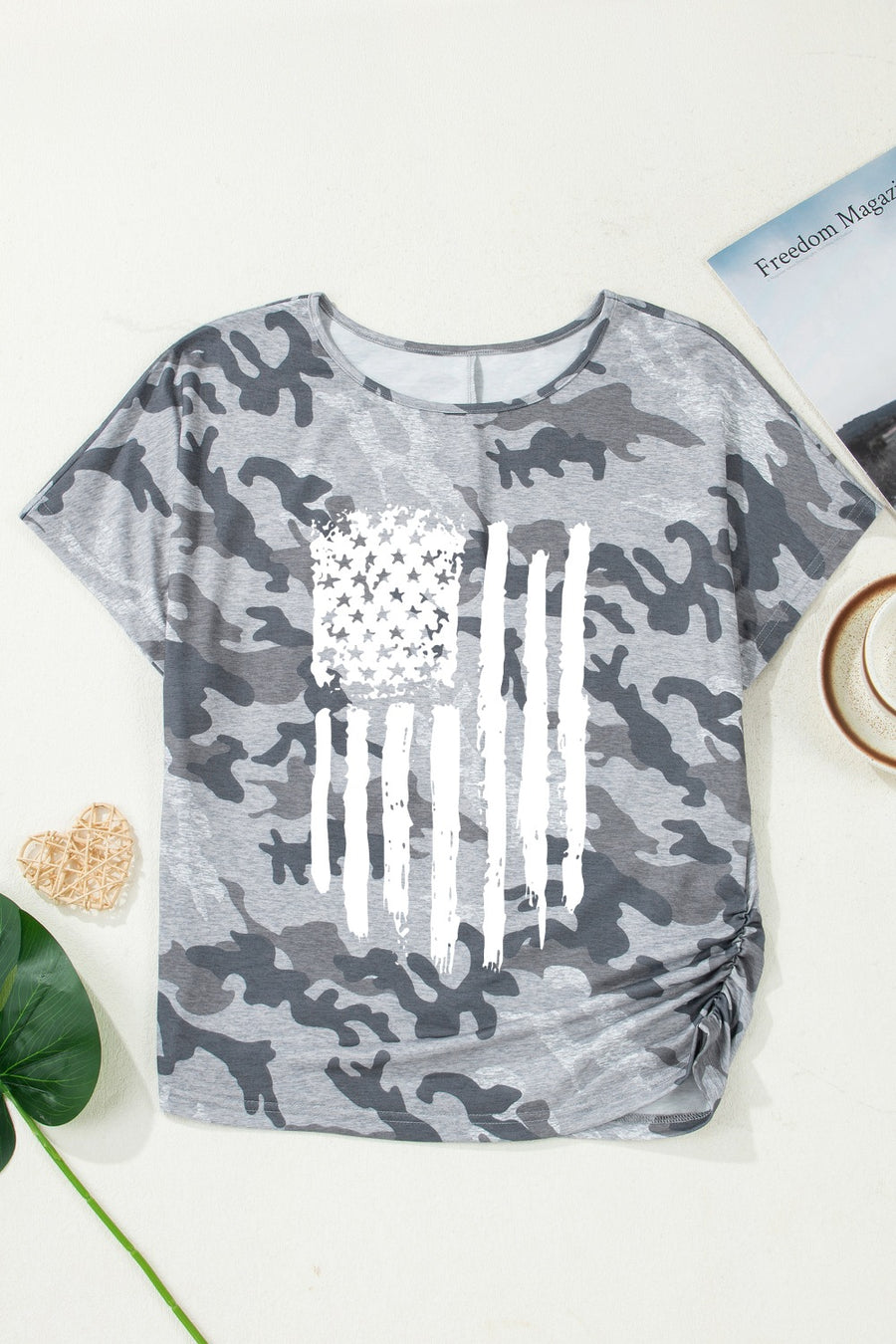 Grey camouflage crew neck t-shirt with distressed American flag graphic and ruched side detail.