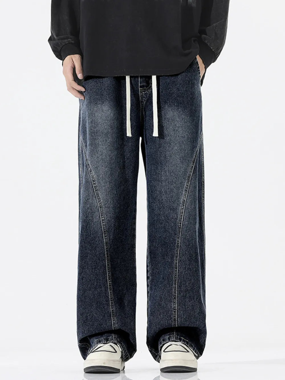 Relaxed fit dark wash wide-leg jeans with drawstring waist and contrast stitching.