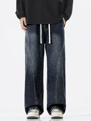 Relaxed fit dark wash wide-leg jeans with drawstring waist and contrast stitching.