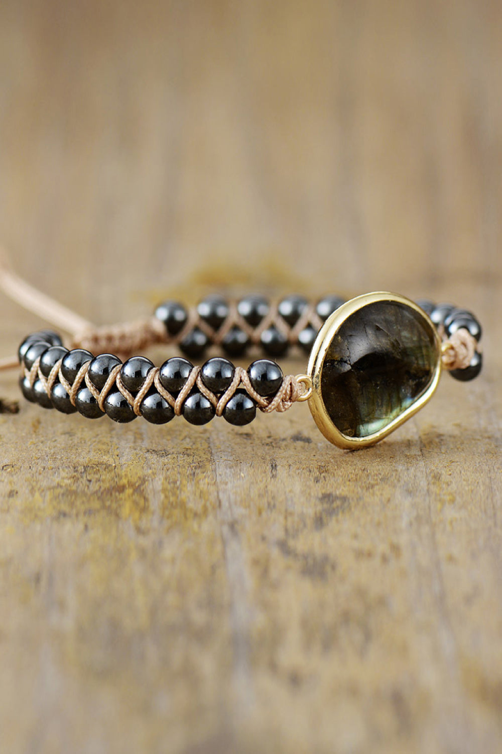 Black beaded bracelet with labradorite stone and braided detail