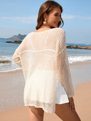 Cream open-knit beach sweater with boat neck and long sleeves.