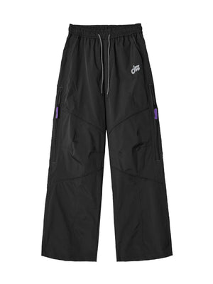 Relaxed fit cargo pants in Blue Night Black with drawstring and purple zipper accents.