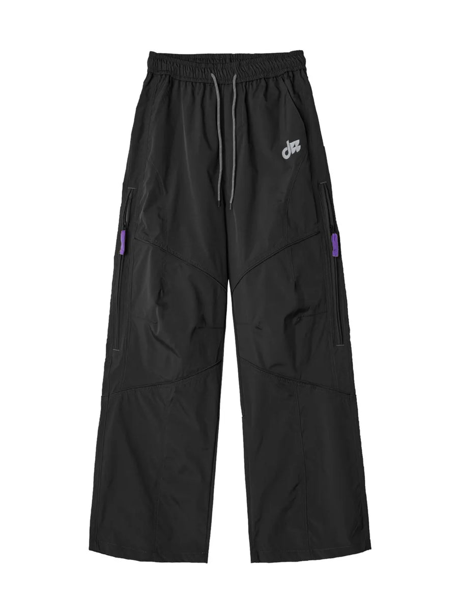 Relaxed fit cargo pants in Blue Night Black with drawstring and purple zipper accents.