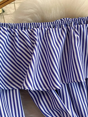 Blue and white striped off-shoulder ruffled romper with elastic neckline.