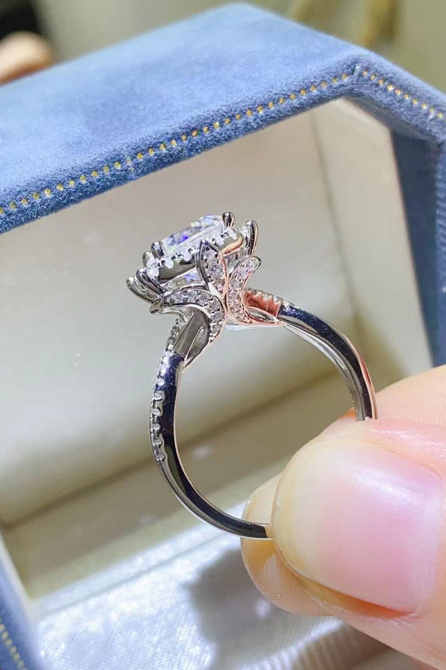 Silver moissanite engagement ring with halo and diamond accents on band