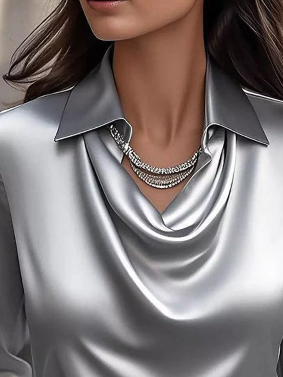Gray satin cowl neck blouse with a collared neckline and layered necklace.