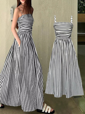 Black and white striped maxi dress with spaghetti straps, smocked bodice, and side slit.