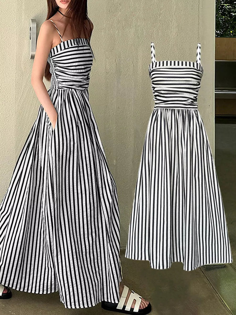 Black and white striped maxi dress with spaghetti straps, smocked bodice, and side slit.