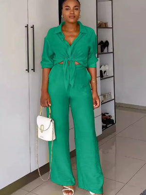 Green tie-front collared shirt and wide-leg pants set with a white handbag.