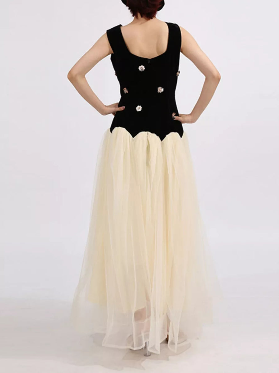 Black velvet sleeveless dress with floral embellishments and a cream tulle skirt.
