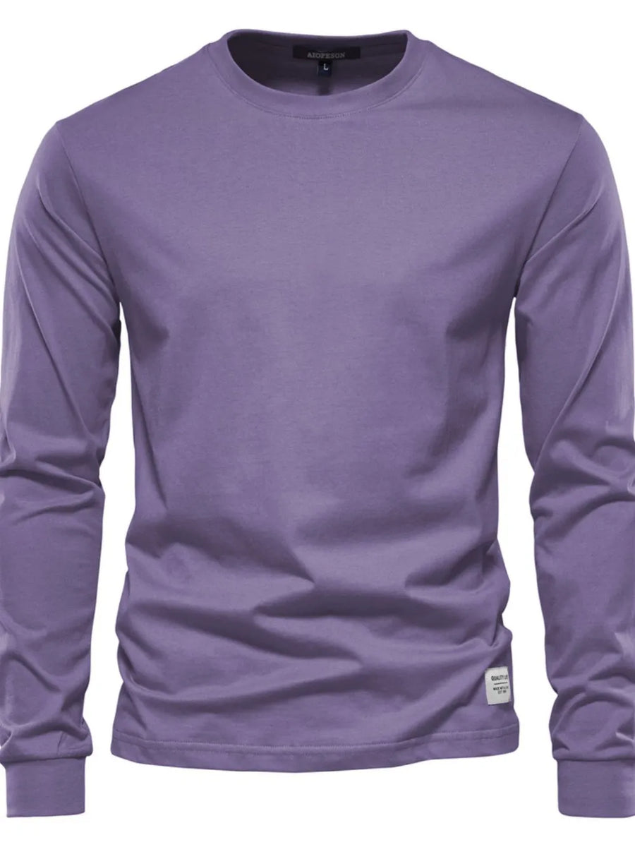 Essential crewneck long sleeve t-shirt in mauve with a small white tag detail on the hem.