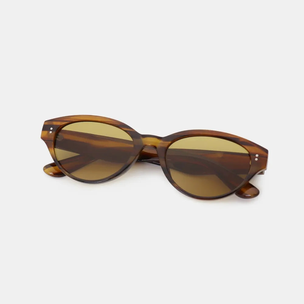 Tortoiseshell oval acetate sunglasses with brown lenses and gold accents.