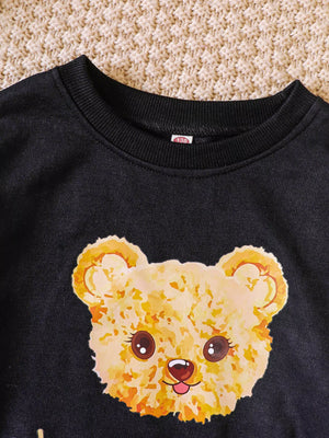 Black crew-neck sweatshirt with a graphic teddy bear face.