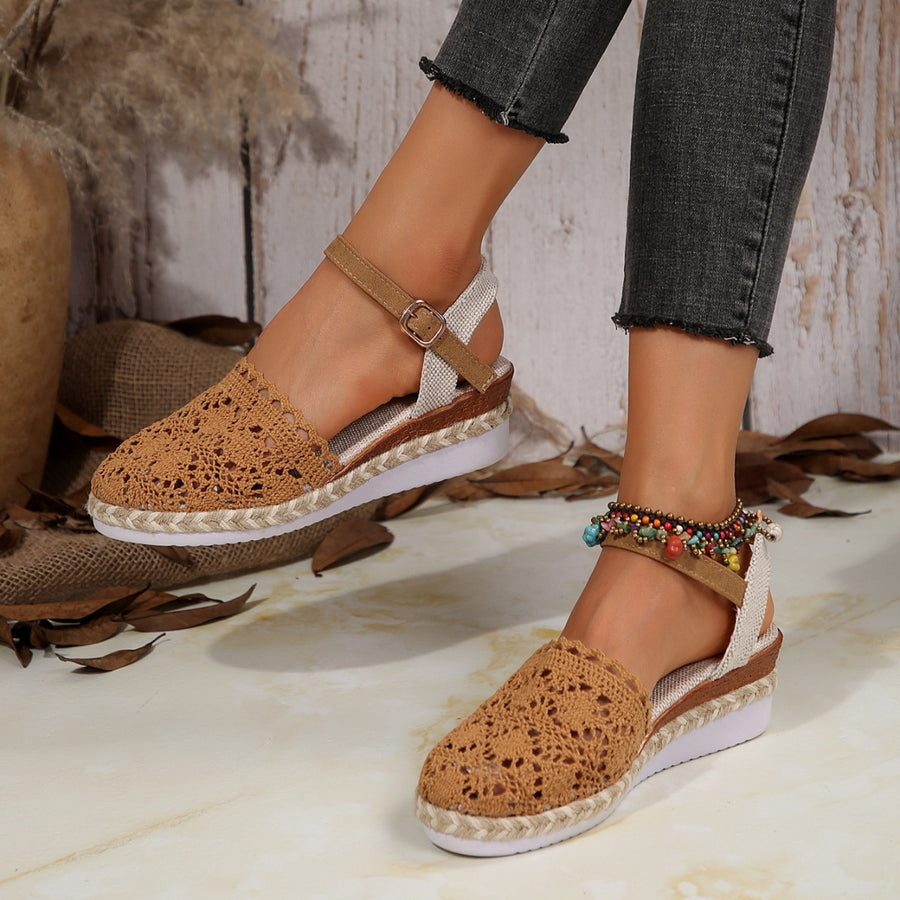 Brown espadrille wedge sandals with crochet floral detail and adjustable ankle strap.