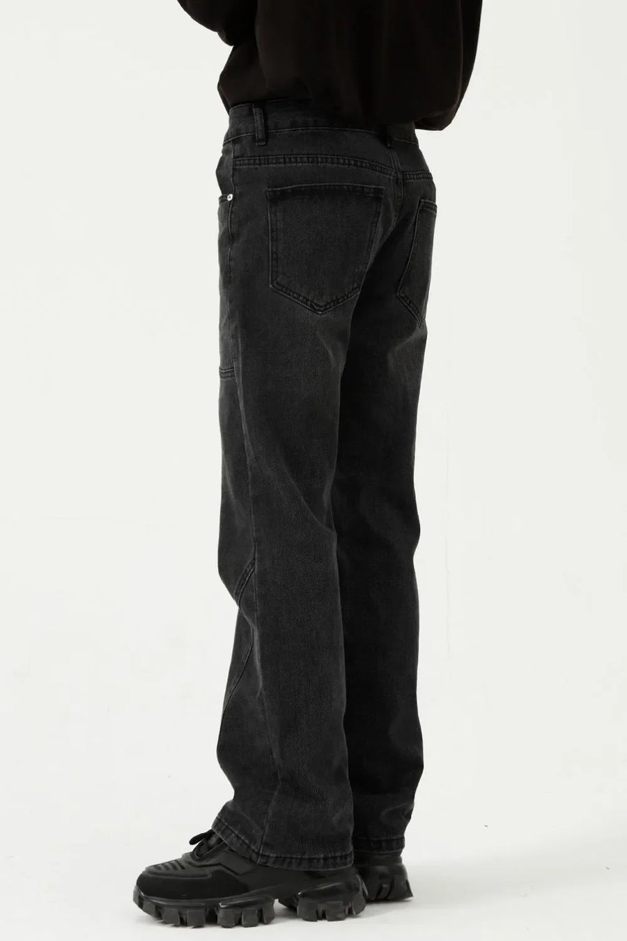 Black denim straight leg jeans with panel seams and a relaxed fit.