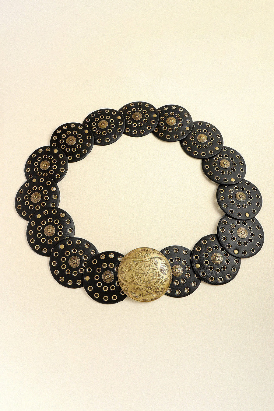 Black leather belt with round gold-tone disc embellishments and a large ornate gold buckle.