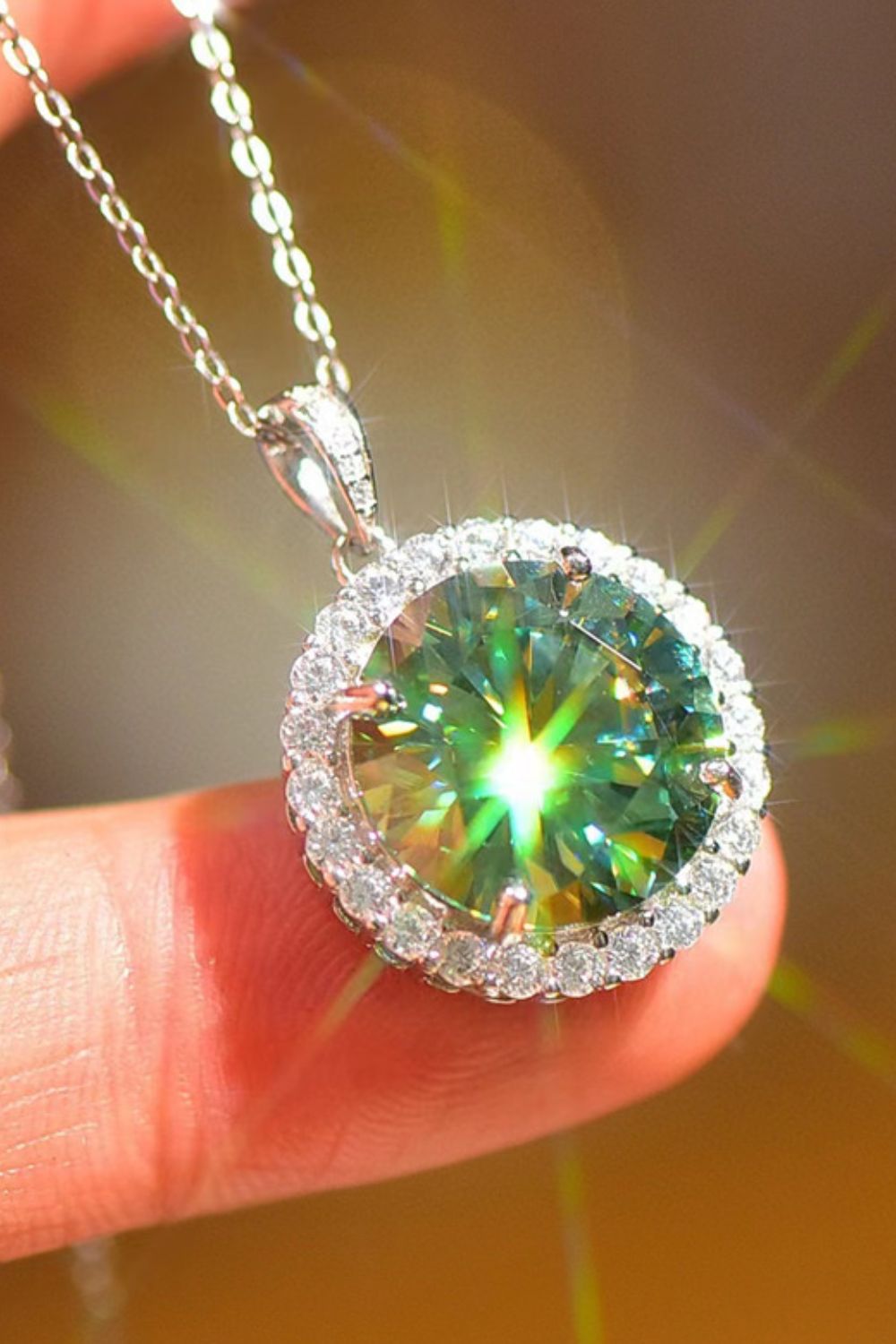 Emerald cut green moissanite halo necklace in platinum with a delicate chain.
