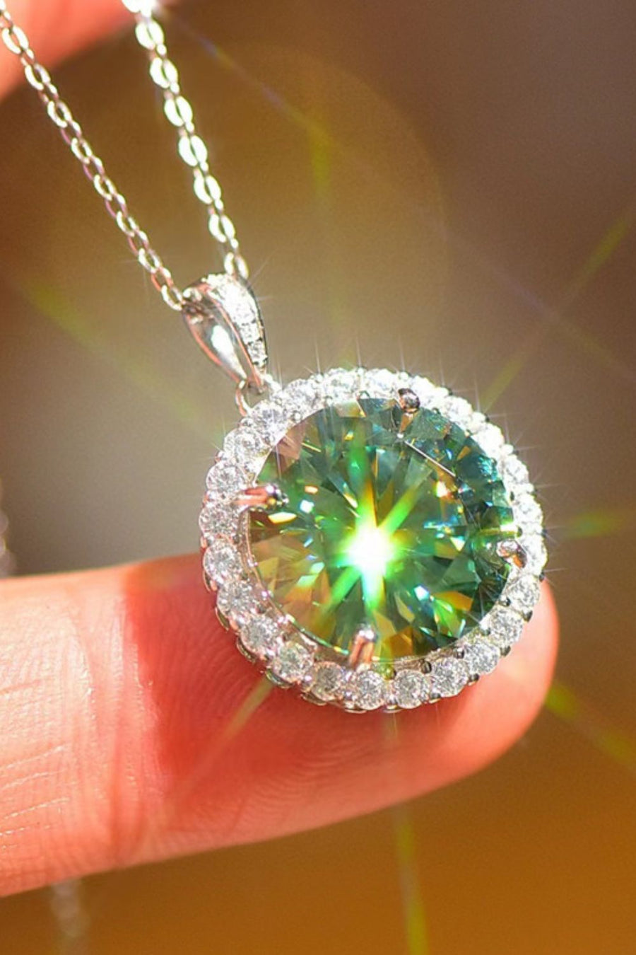 Emerald cut green moissanite halo necklace in platinum with a delicate chain.