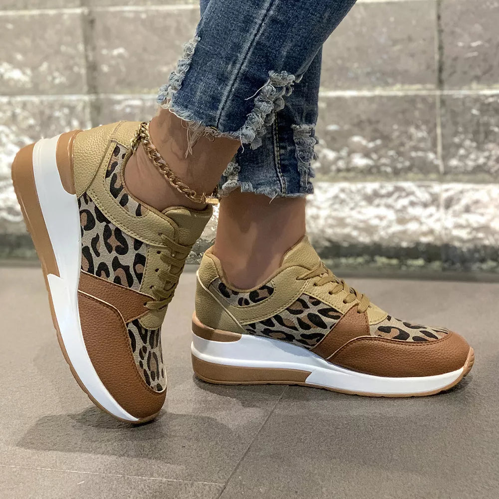 Leopard print lace-up sneakers with brown and tan color-blocking and a white sole.