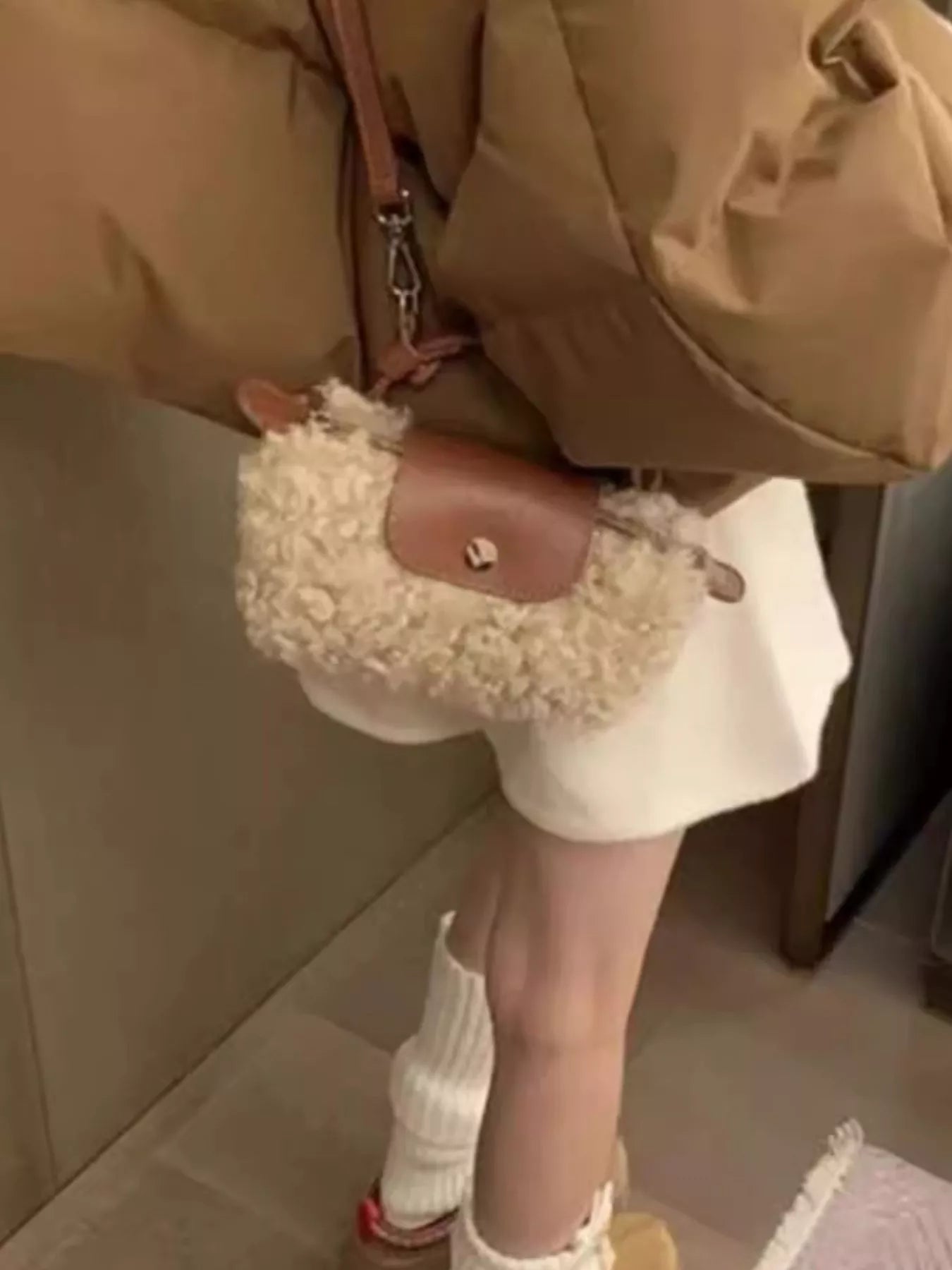Textured mini crossbody bag in khaki with a brown leather flap and strap.