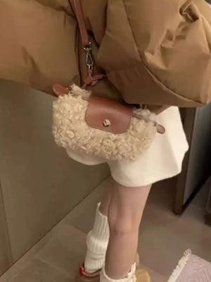 Textured mini crossbody bag in khaki with a brown leather flap and strap.