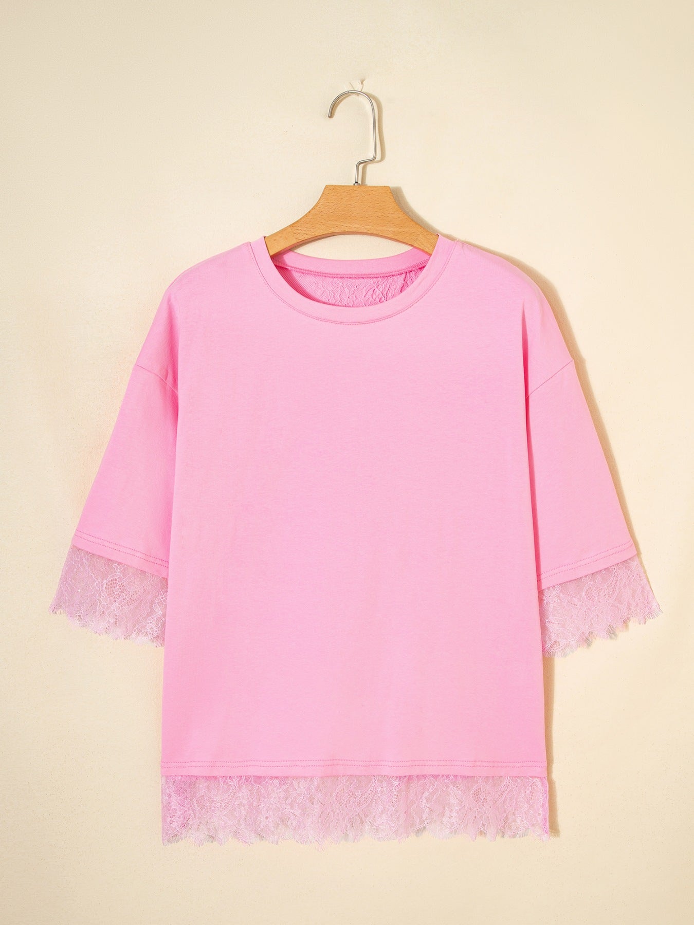 Pink cotton blend oversized tee with floral lace trim on sleeves and hem.