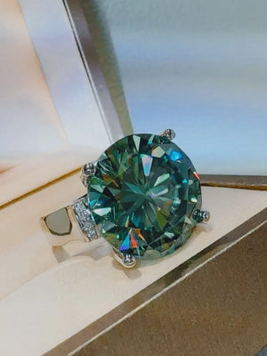 Prismatic teal statement ring with large faceted gemstone and pave band.