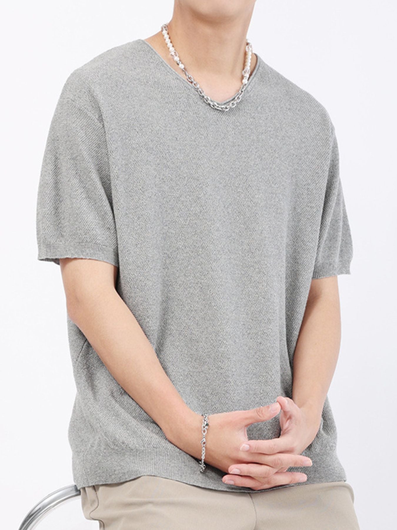 Men's gray short-sleeve knit t-shirt with V-neck and textured fabric.