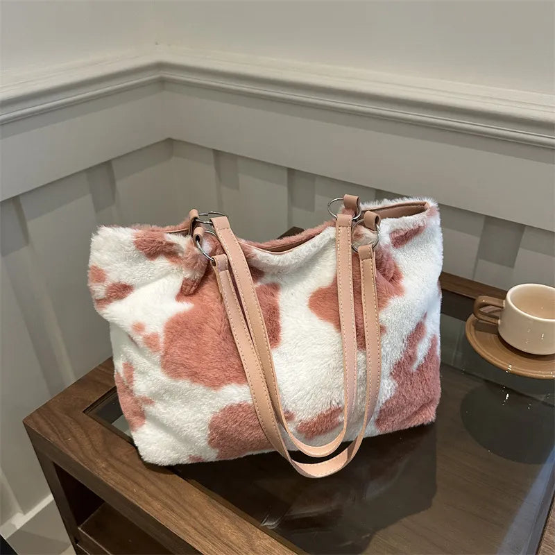 Dusty pink and white cowhide print faux fur shopper bag with pink straps.