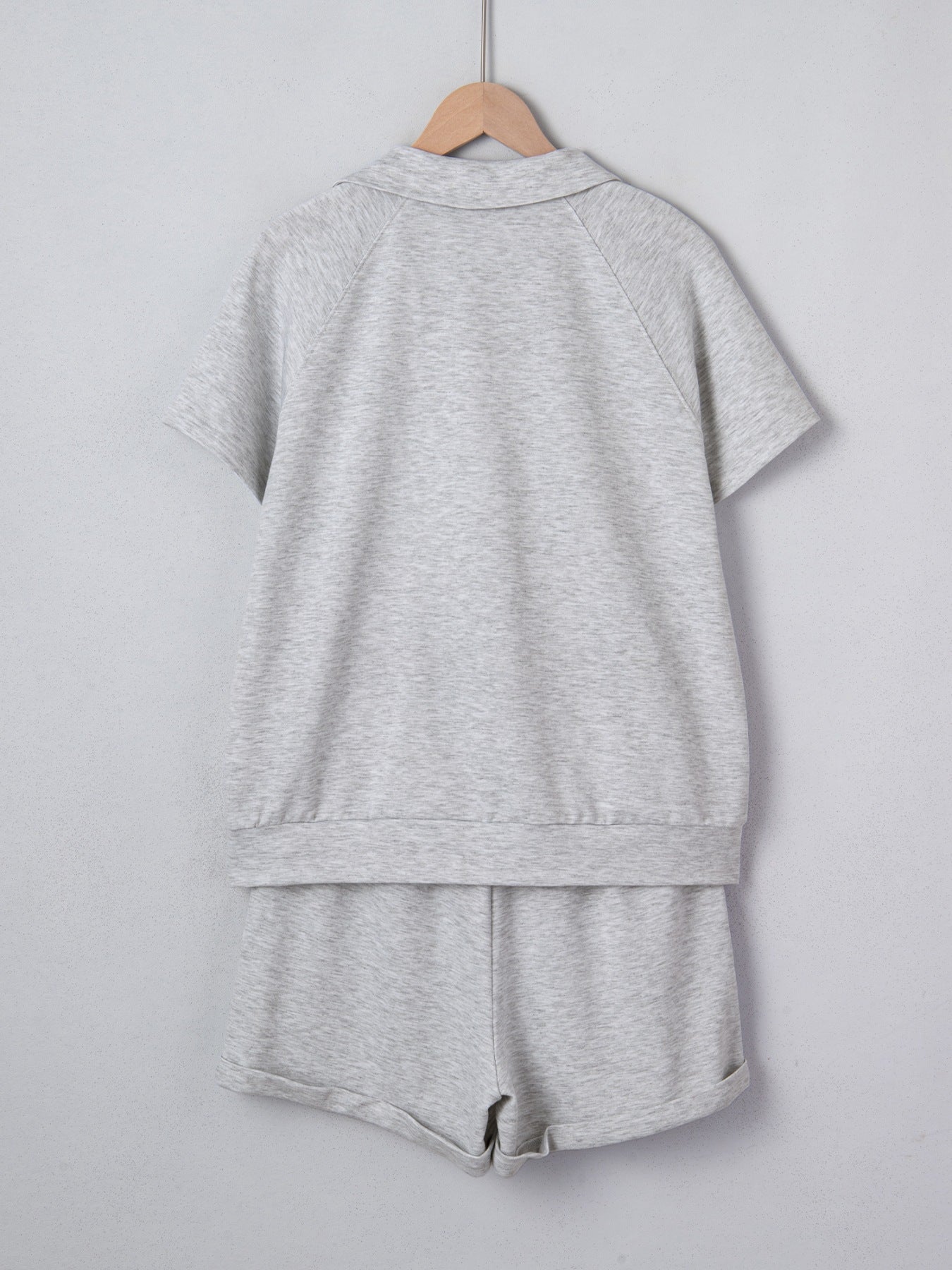 Grey polo collar loungewear set with short sleeves and shorts made of polyester.