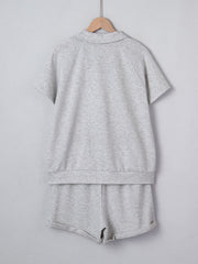 Grey polo collar loungewear set with short sleeves and shorts made of polyester.