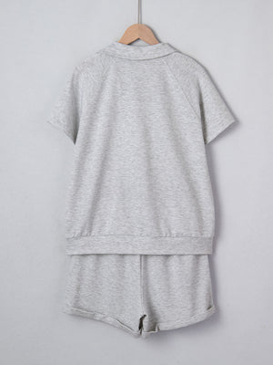 Grey polo collar loungewear set with short sleeves and shorts made of polyester.