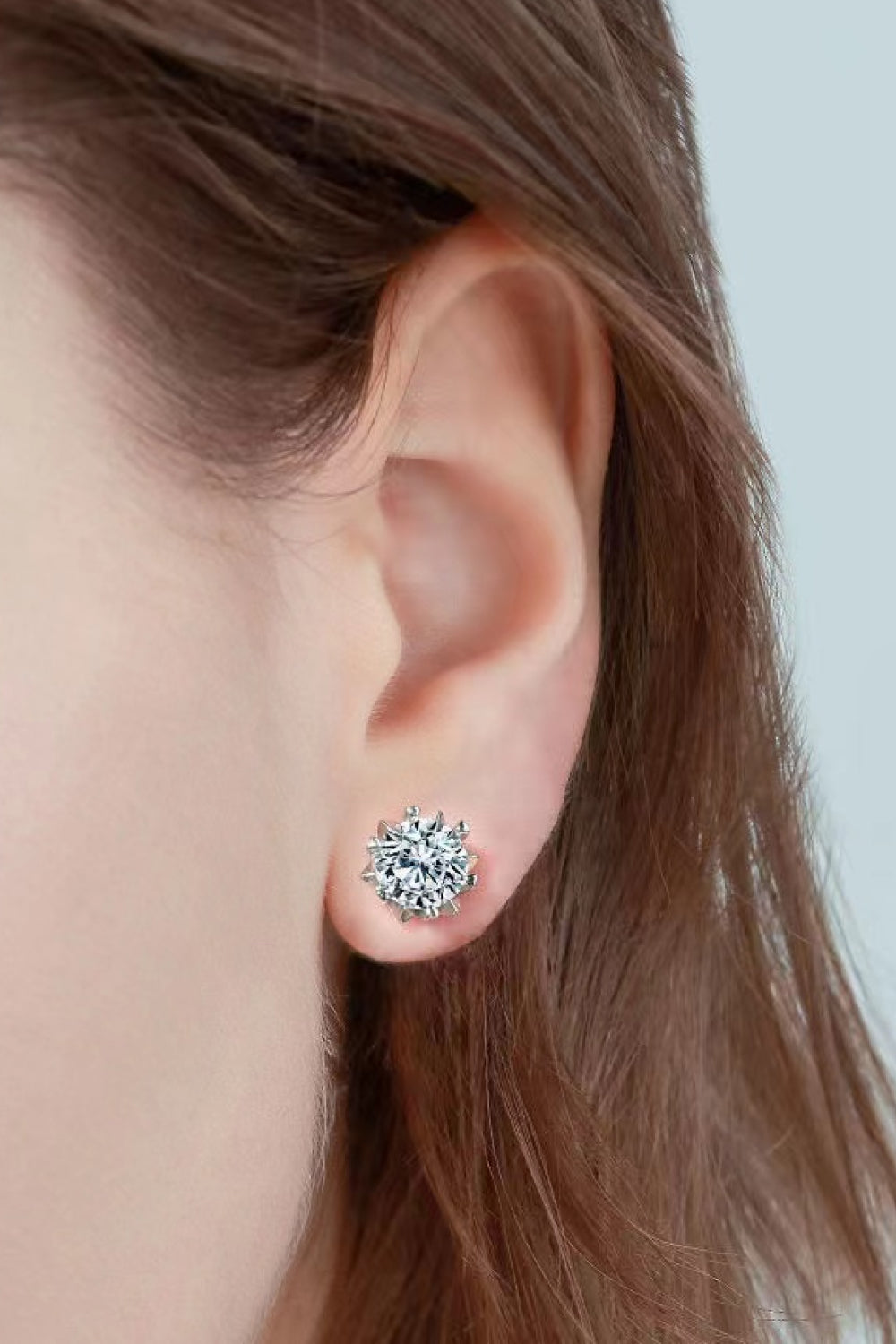 Silver moissanite stud earrings with celestial cut gemstone detail.