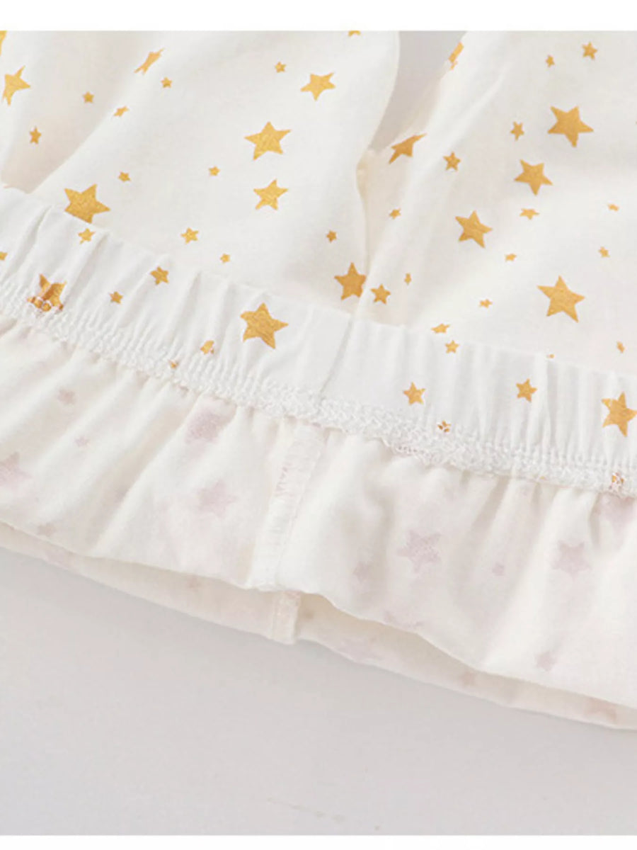 Baby girls' pajama shorts in blush pink with gold stars and ruffled hem