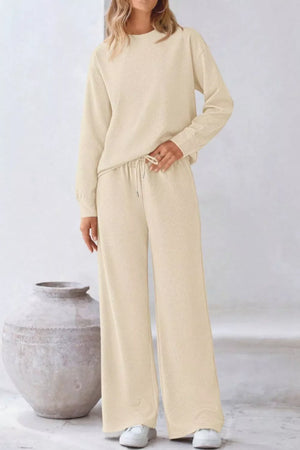Apricot loungewear set with drawstring pants and a textured crewneck sweatshirt.