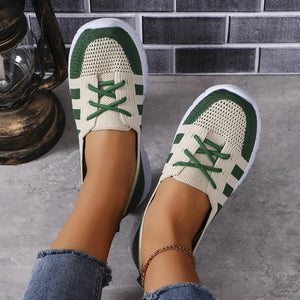 Breathable knit lace-up sneakers in beige with green accents and white soles.
