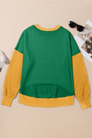 Green and yellow contrast crewneck sweatshirt with long sleeves and ribbed cuffs and hem.