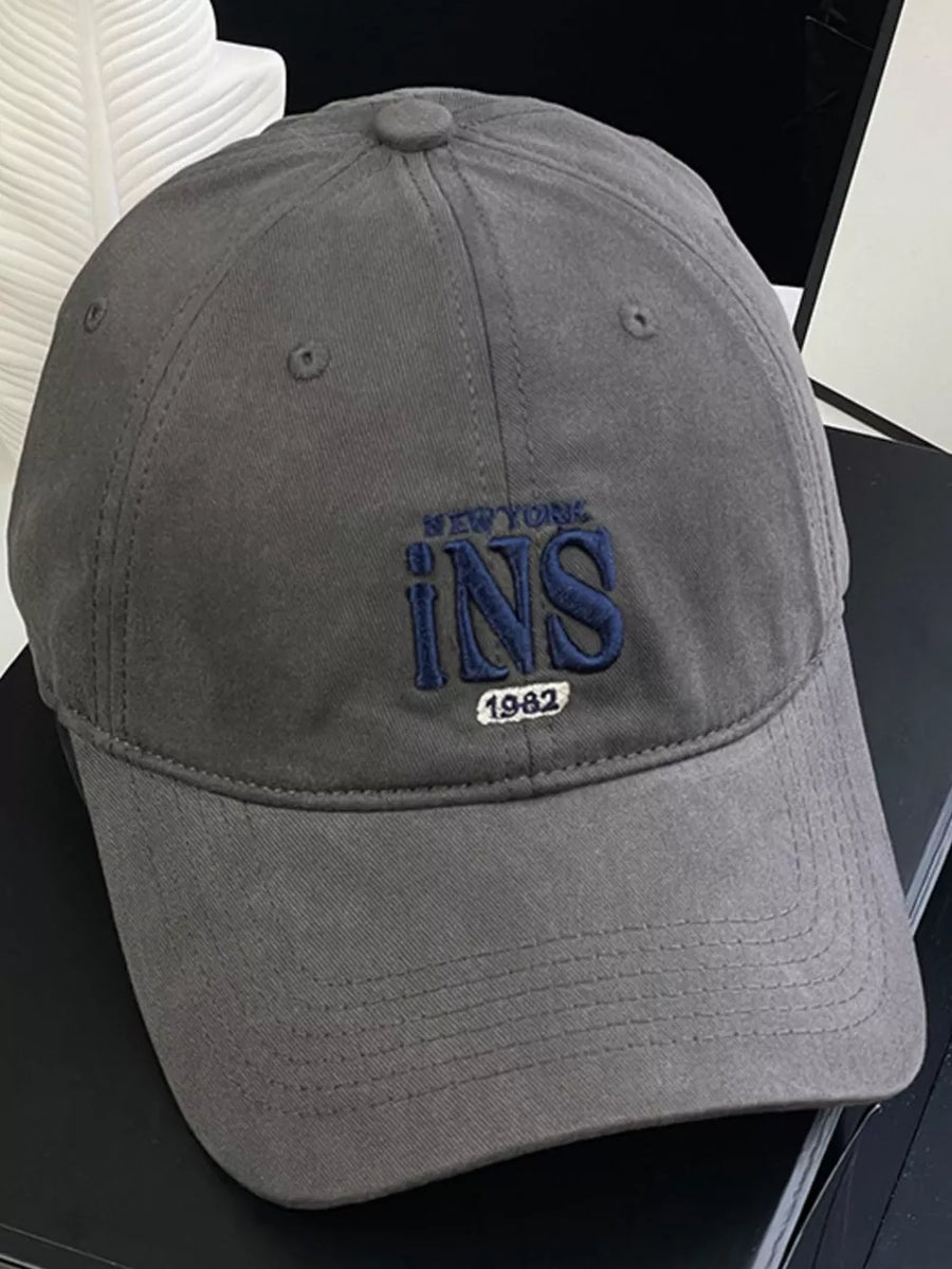 Grey baseball cap with embroidered New York INS 1982 detail