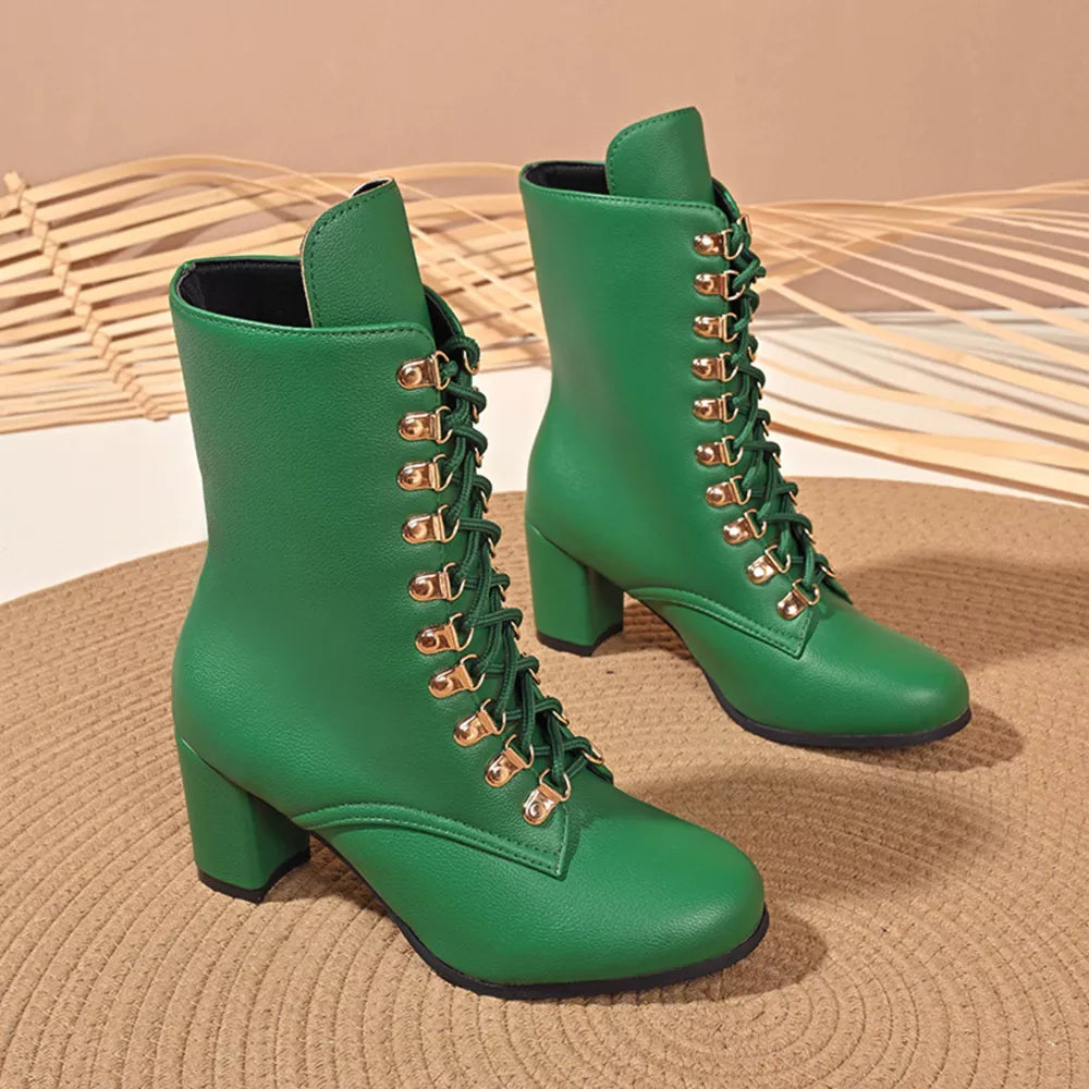 Green lace-up block heel boots with gold eyelets and laces.