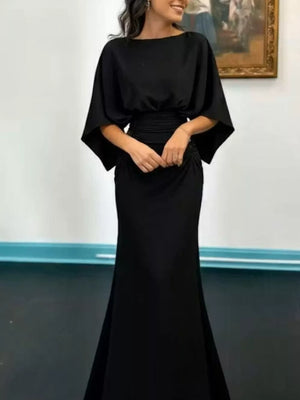 Black batwing sleeve maxi dress with ruched waist and cinched skirt.