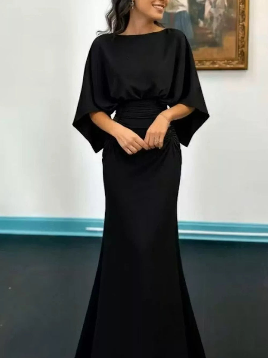 Black batwing sleeve maxi dress with ruched waist and cinched skirt.