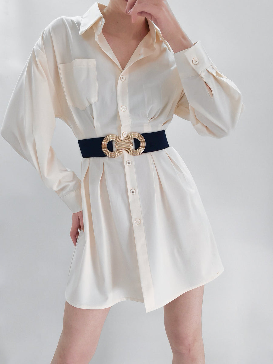 Black stretch belt with interlocking gold buckle detail