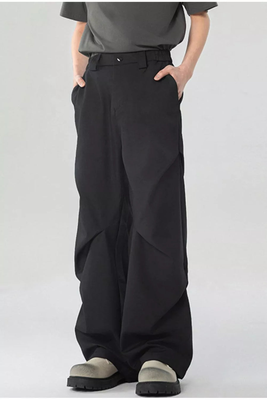 Black men's wide-leg sweatpants with pockets and a relaxed fit.