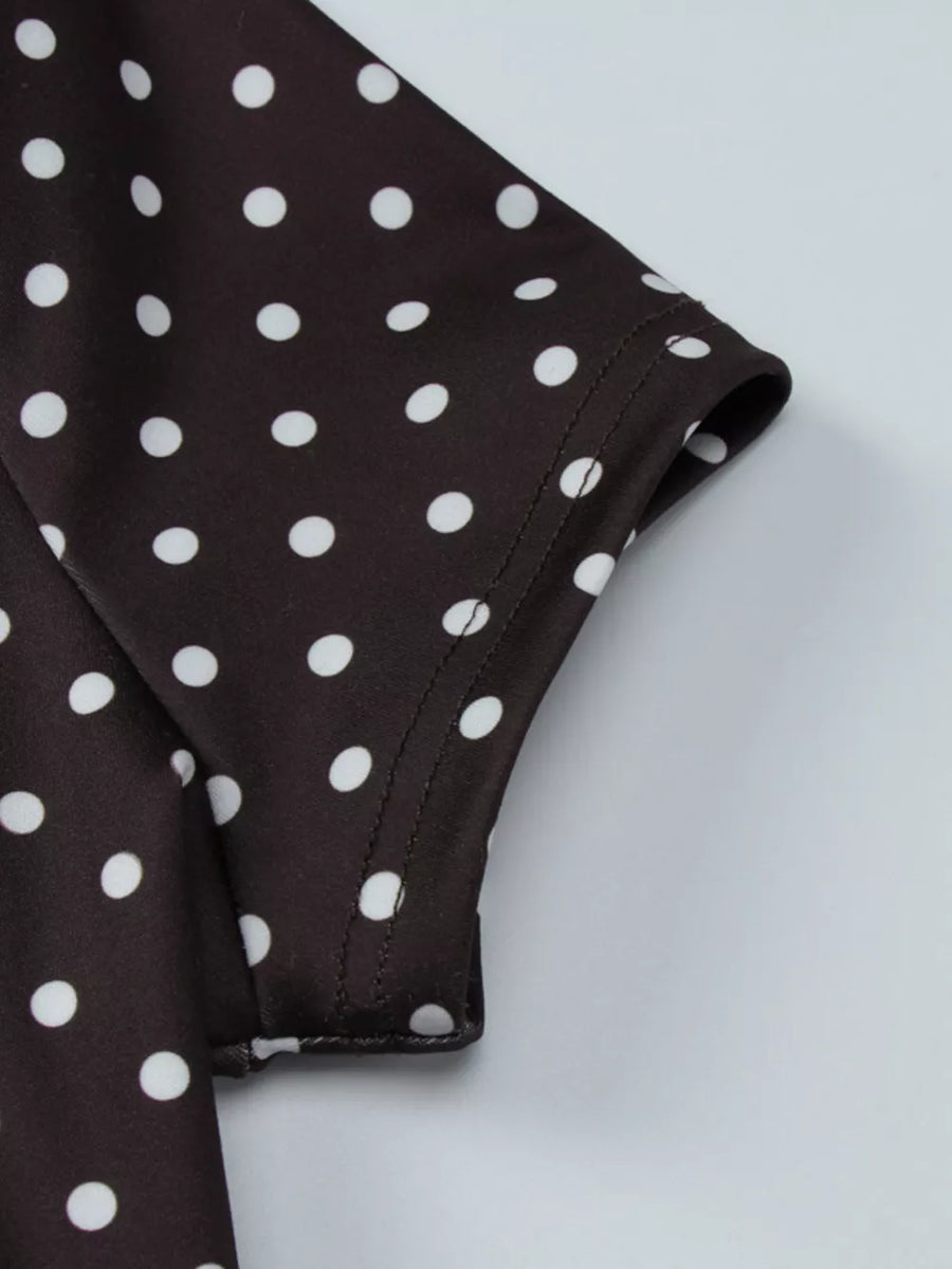 Brown polka dot mini dress with short sleeves and cut-out detail.