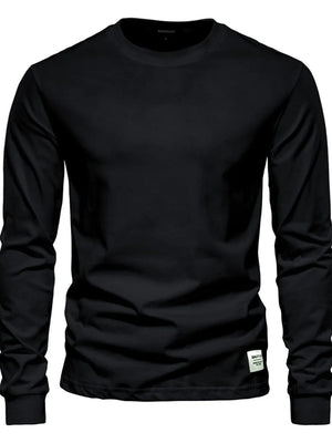 Black crewneck long sleeve t-shirt with a small white tag detail on the hem.