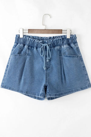 Medium wash denim shorts with paperbag waist, drawstring, and relaxed fit