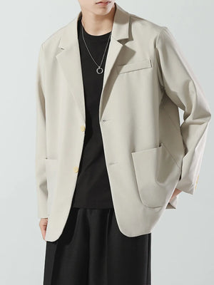 Men's beige relaxed fit blazer with two buttons and patch pockets.