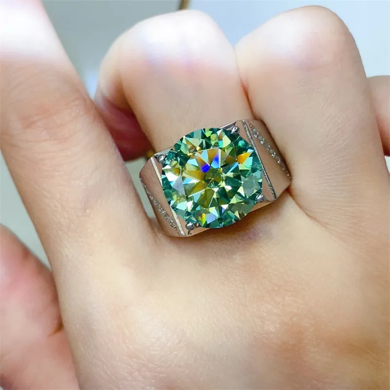 Emerald cut moissanite signet ring in silver with a large green stone and small accent stones.