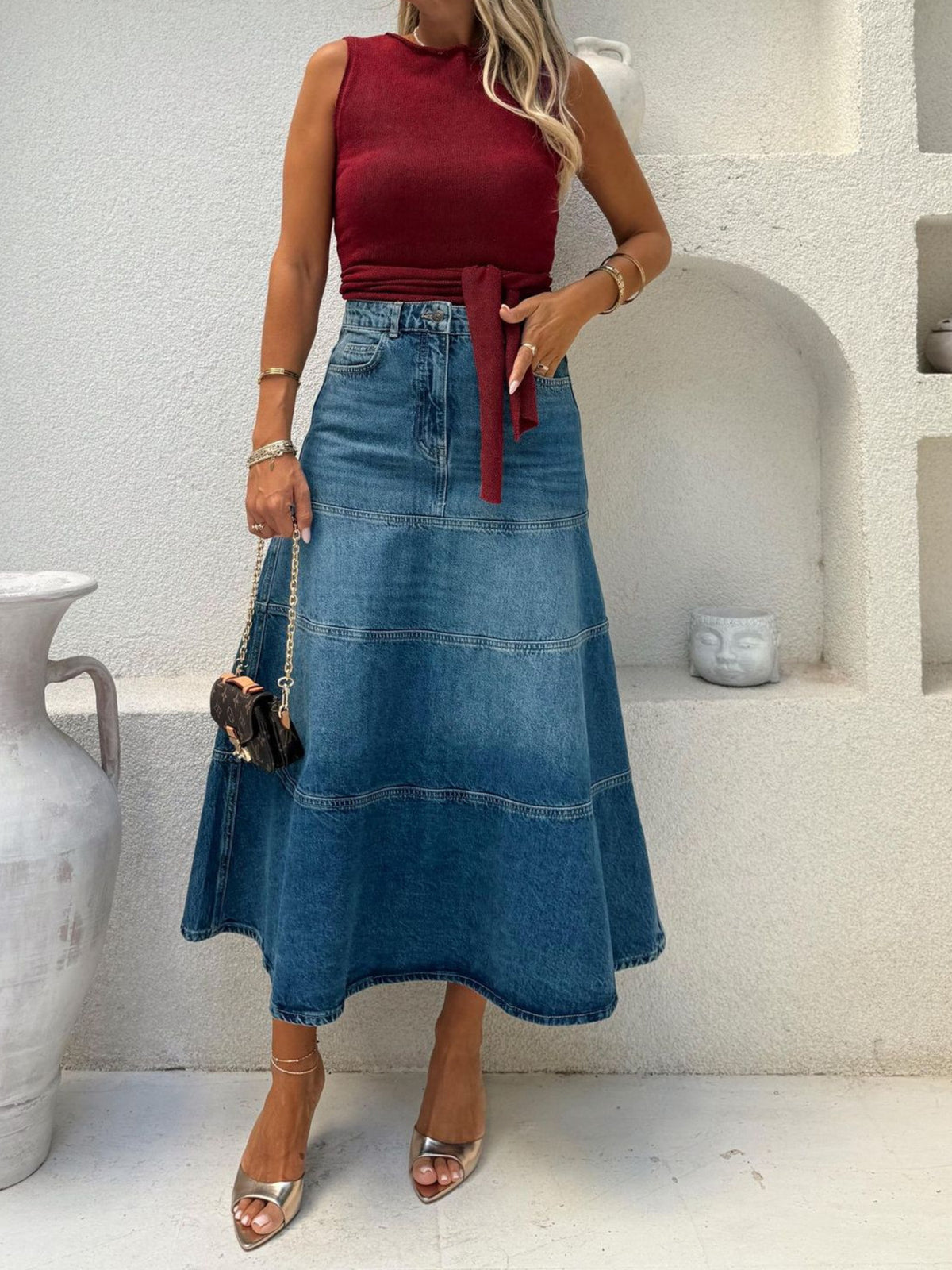 Plus high-waisted A-line denim skirt in dusty blue, featuring tiered panels and a midi length.